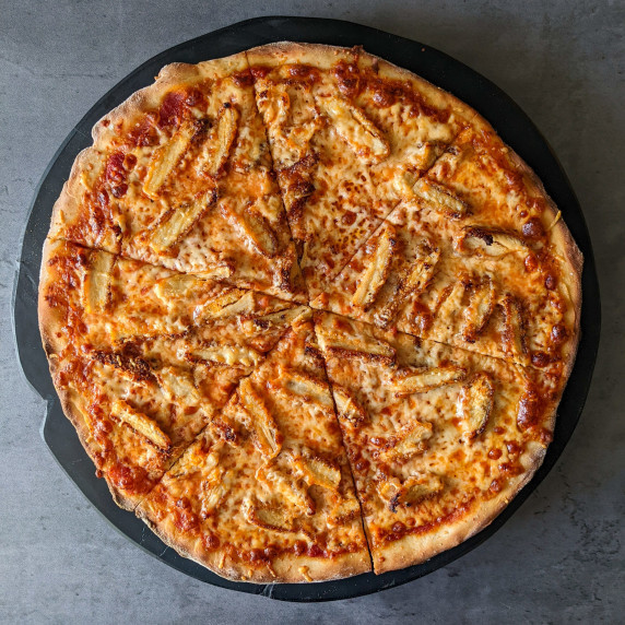 A thin-crust cheesy pizza topped with breaded chicken and parmesan