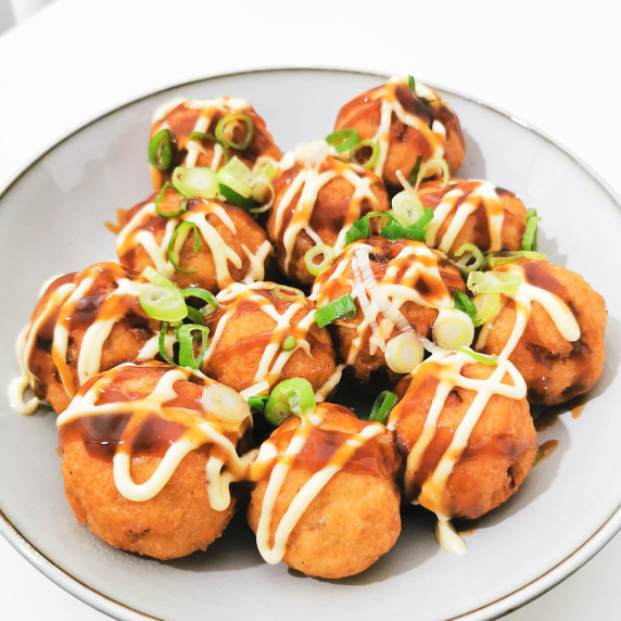 Japanese chicken and tofu meatballs topped with sauces and green onion