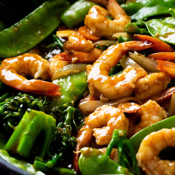 A skillet full of Chinese curry prawns stir fry