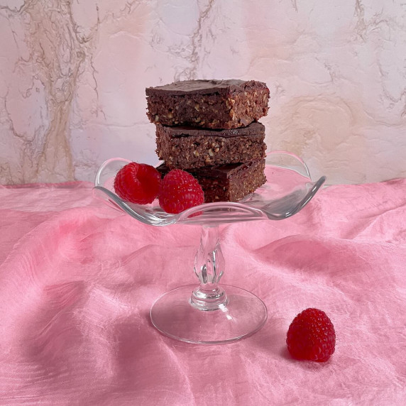 Three Chocolate Raspberry Brownies stacked on a pink plate.