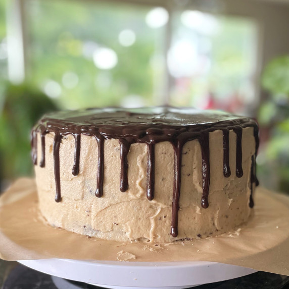a whole cake with peanut butter frosting and chocolate ganache drip