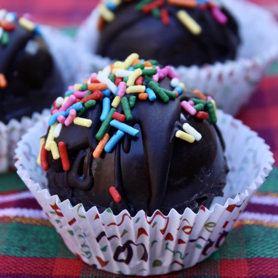 Mexican Hot Chocolate Bombs with Sprinkles on a plaid tablecloth