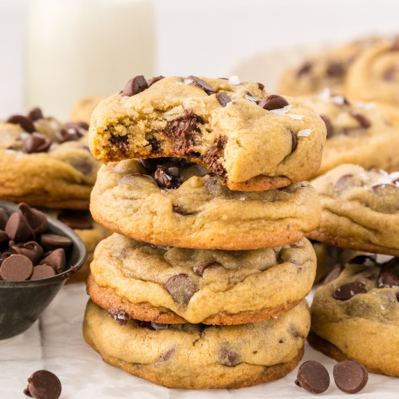 Chocolate Chip Cookies stacked with the top cookie bitten.