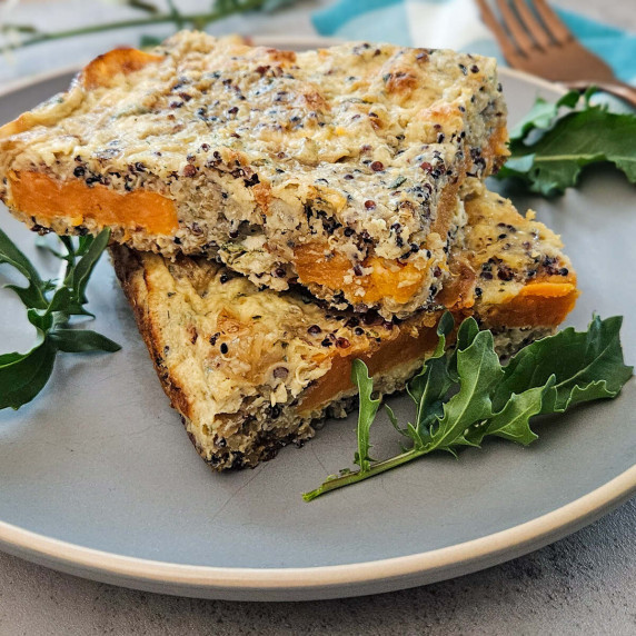 plated squares of roasted sweet potato quinoa bake with fresh arugula