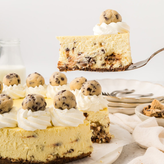 cookie dough cheesecake with a slice being taken out