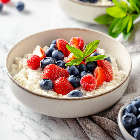 Bowl with cottage cheese and mixed berries on top
