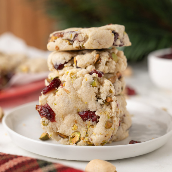 Stack of cranberry shortbread cookies on plat.