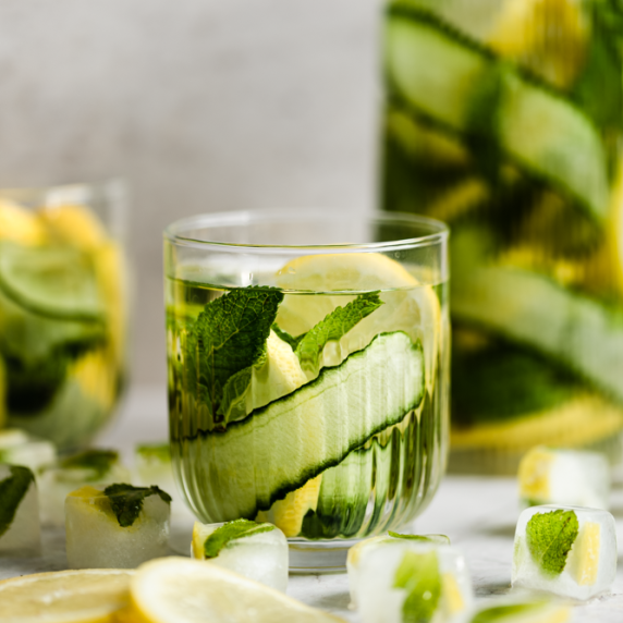 Cucumber Detox water recipe arranged in aesthetic cups with ice cubes on the side