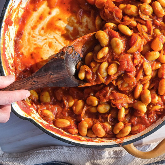 Close up of curries butter beans in a pan 