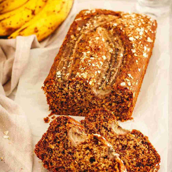 Sliced dairy free banana bread on white parchment paper.