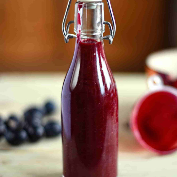 A glass bottle of home made damson ketchup
