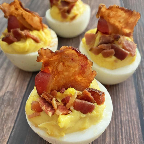 Close up of bacon topped deviled eggs.