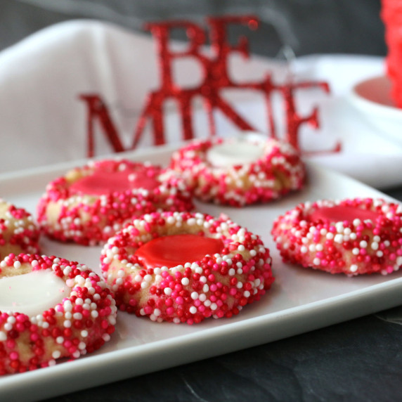 Valentines thumbprint cookies on a white tray.