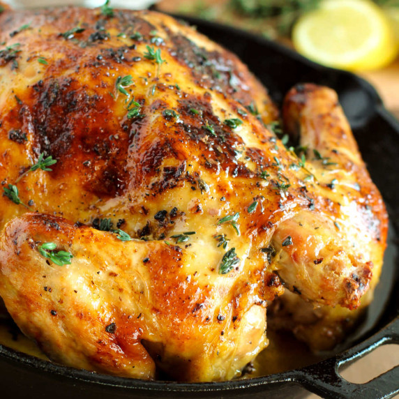 A whole roasted chicken in an iron skillet.