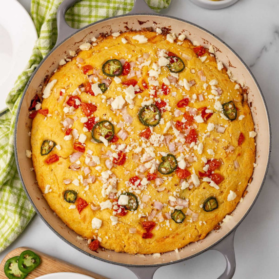 A cast iron skillet with cheddar cheese cornbread.