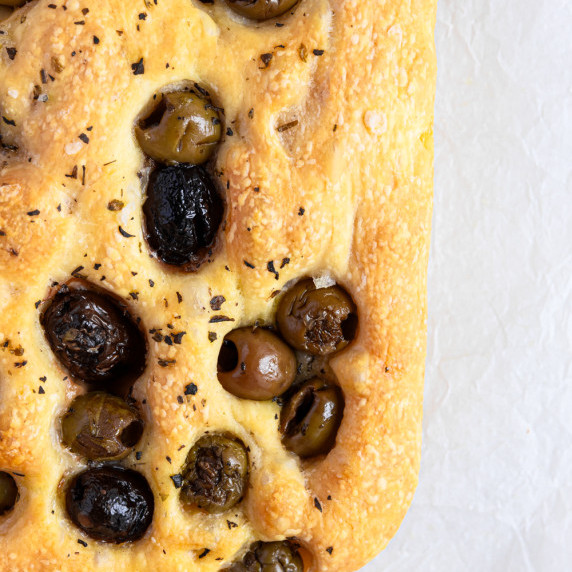 Freshly baked olive focaccia with golden crust