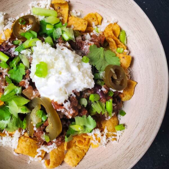 Crispy corn chips smothered in chili with sour cream, fresh cilantro, and pickled jalapenos.