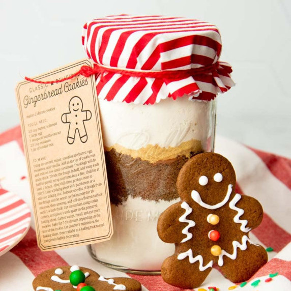 Gingerbread cookie mix packaged in a Ball jar for gifting with a recipe tag and gingerbread cookie.