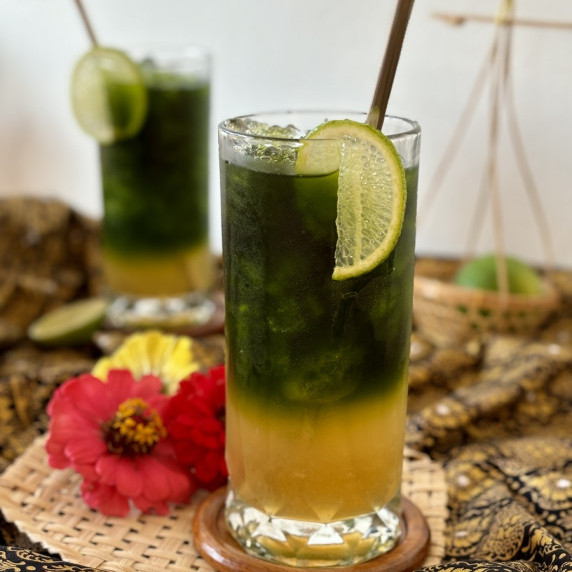 Green Thai tea serving in a tall glass.