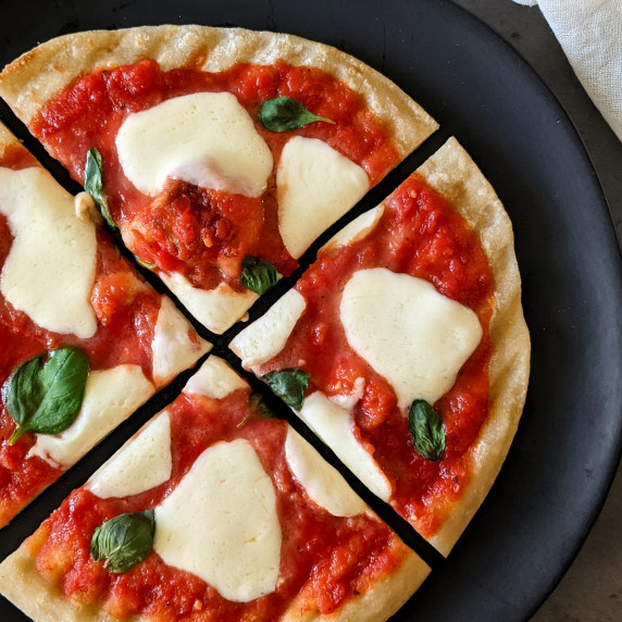 A mini grilled margherita pizza on a plate