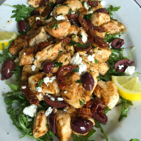 A platter of pan seared Mediterranean chicken bites with feta, kalamata olives, sun dried tomatoes. 
