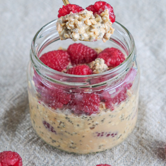 High protein overnight oats with raspberries in a mason jar 