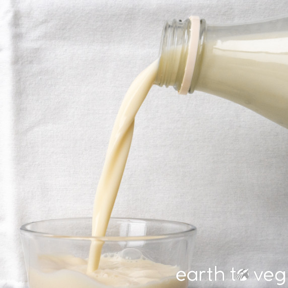 soy milk being poured from a bottle