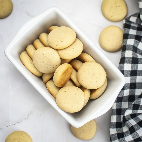 Overhead shot of vanilla wafers in a rectangular ceramic dish on a marble surface.