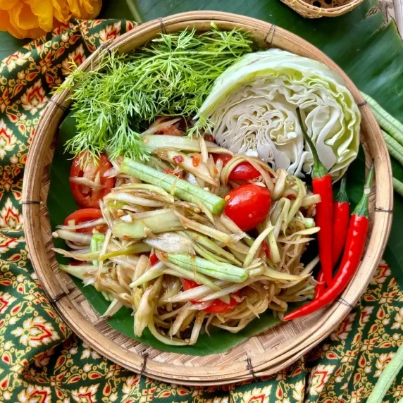 Lao papaya salad served with lettuce, dille, and chilies.