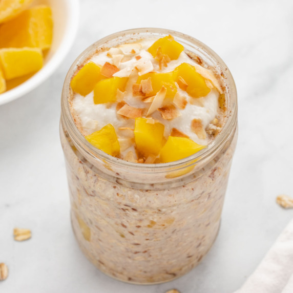 mango overnight oats in a jar with diced mango