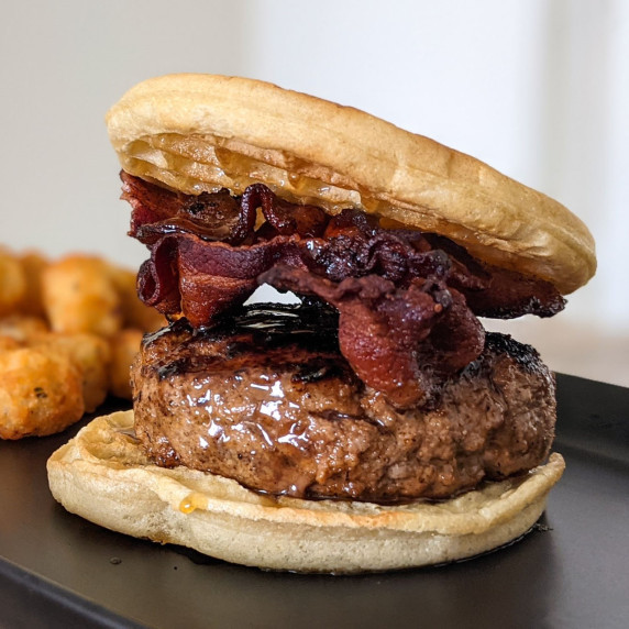 A juicy burger topped with bacon and maple bourbon syrup served between two waffles