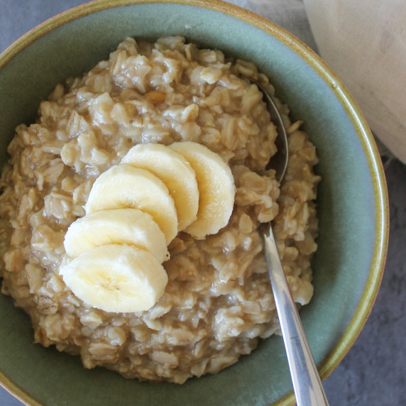A bowl of maple brown sugar oatmeal topped with sliced banana