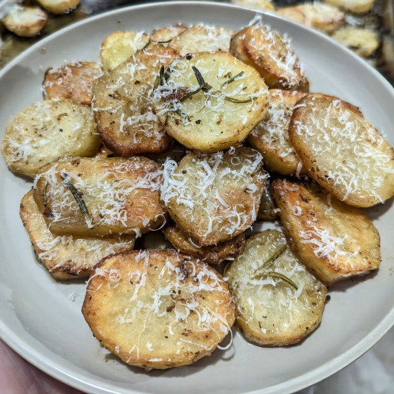 A plate with parmesan melting potatoes piled on it.