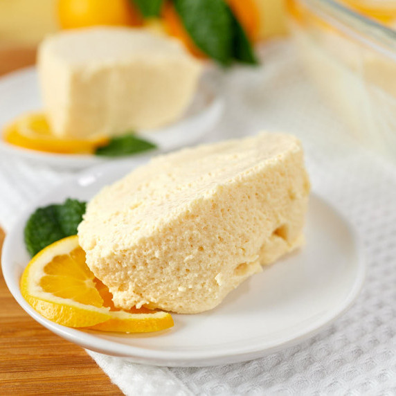 Slices of gelatina de leche evaporada (Mexican milk jello) decorated with fresh fruit.