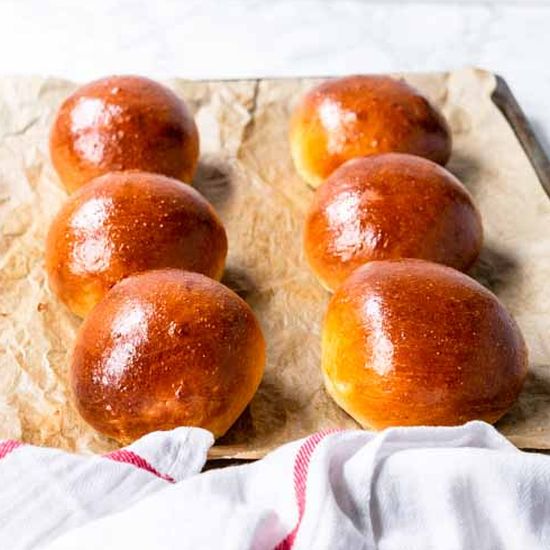 Four Japanese milk bread rolls on a white cloth