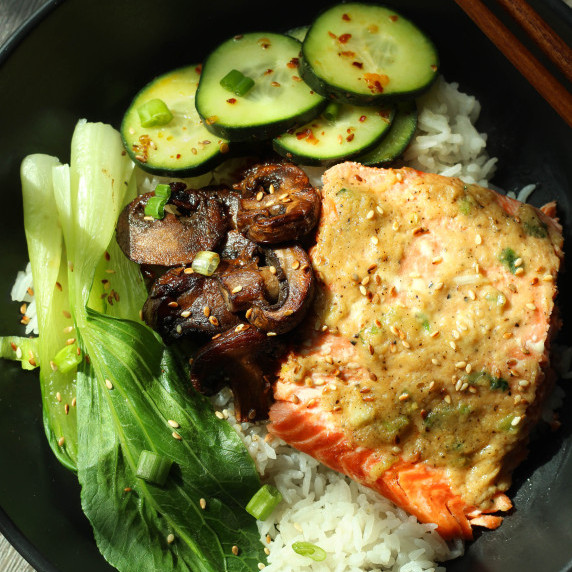Miso butter salmon with rice with bok choy, mushrooms, and cucumber salad.
