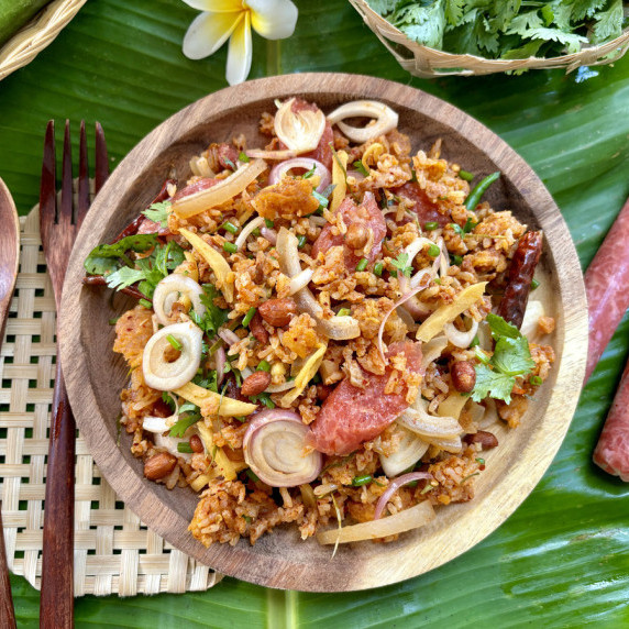 Thai crispy rice salad, nam khao tod, served in a wooden dish.
