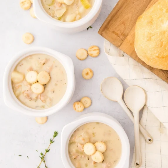 clam chowder in white bowls with crackers