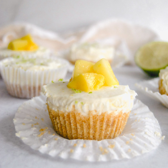 mini no bake mango lime cheesecake on gray background