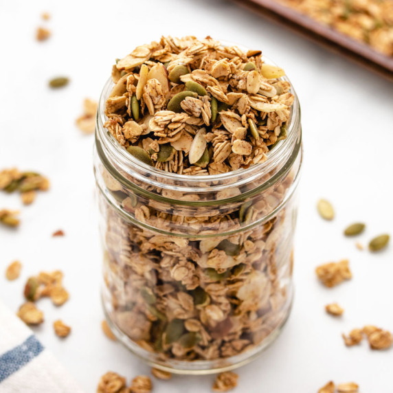 Oil-free granola in a glass jar and a white background.