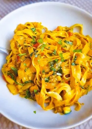 roasted vegetables tagliatelle in a white bowl