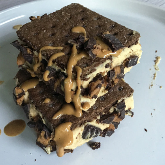 Greek yogurt peanut butter filling sandwiched between two chocolate graham crackers.