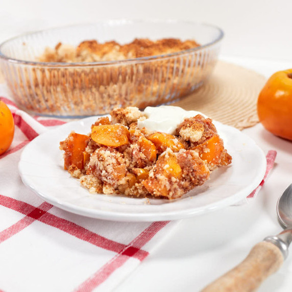 Persimmon crumble served on dessert plate.