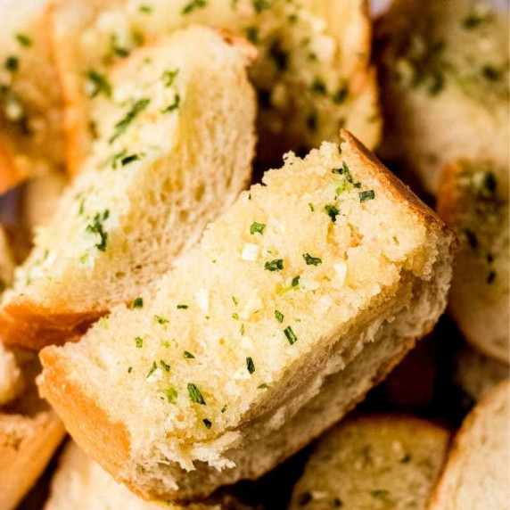 Close view of slices of garlic bread made from french bread and easy homemade garlic butter.