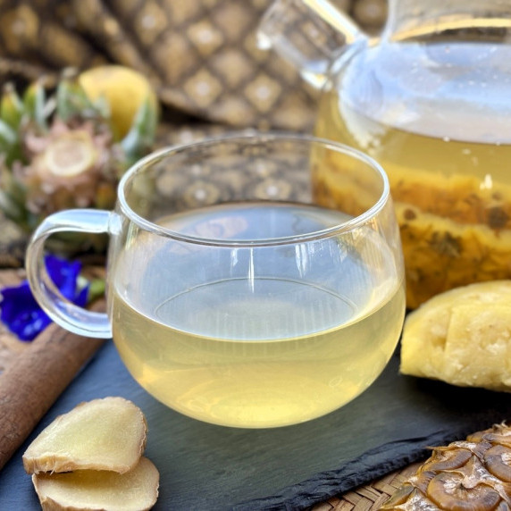 Pineapple tea served on a black dish.