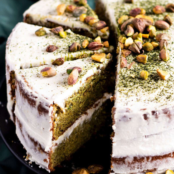 Three slices cut off a pistachio and matcha cake.