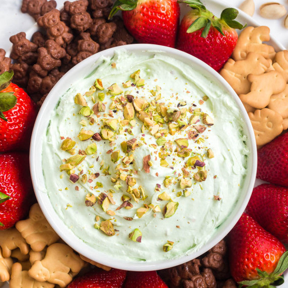 overhead view of a green pistachio dessert dip with crushed pistachios on top.