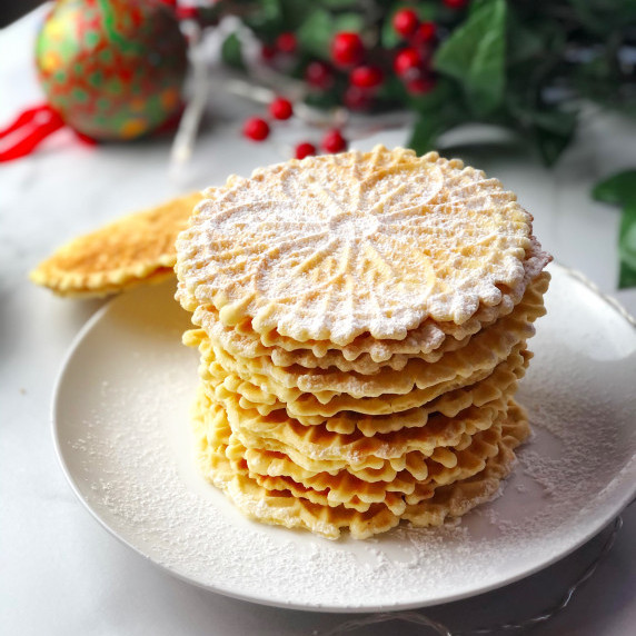 pizzelle cookies stacked up on plate
