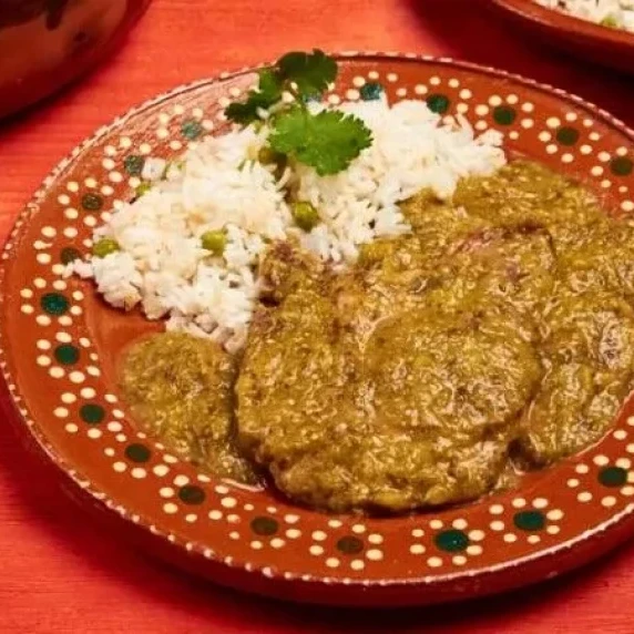 Pork Chops in Salsa Verde with rice served in a plate