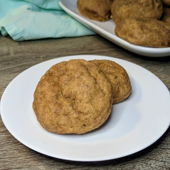 Two snickerdoodles on a palte.